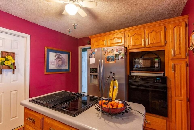 kitchen with a textured ceiling, ceiling fan, and black appliances