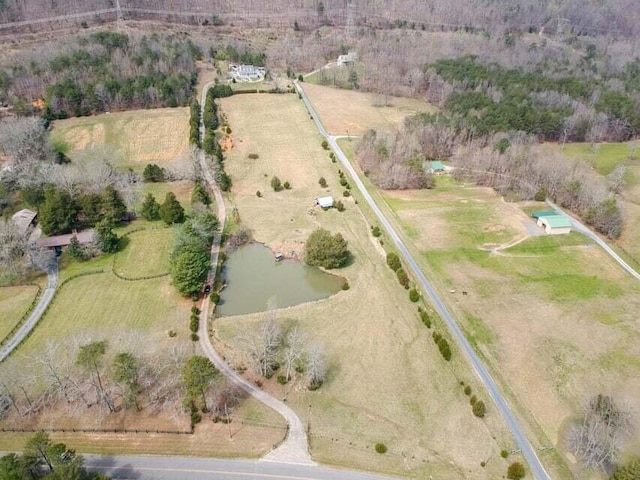 birds eye view of property featuring a rural view and a water view