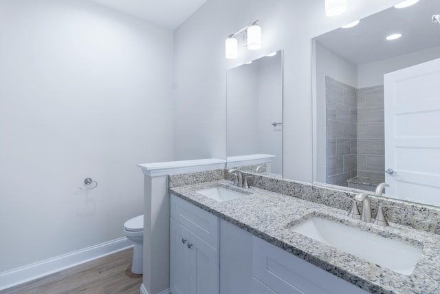 bathroom with vanity, hardwood / wood-style flooring, and toilet