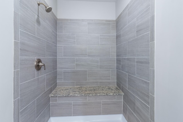 bathroom with a tile shower