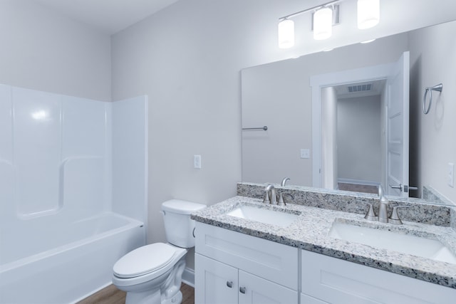 full bathroom with shower / tub combination, vanity, hardwood / wood-style flooring, and toilet