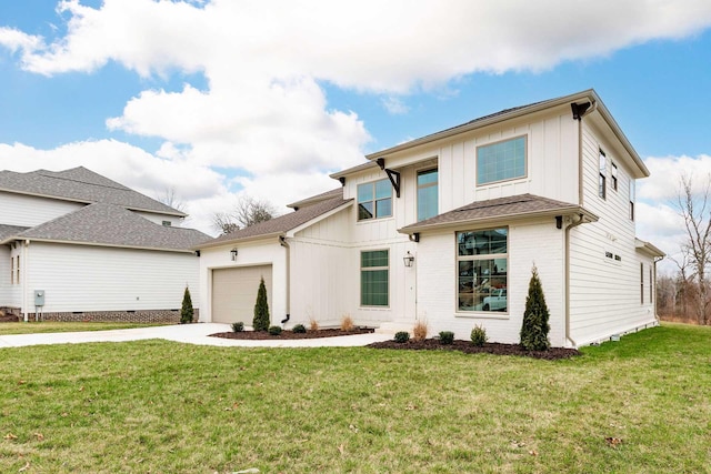 view of front of property featuring a garage and a front yard