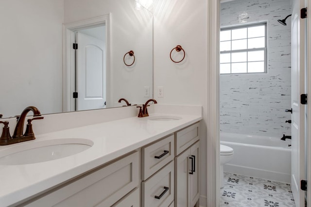 full bathroom featuring tiled shower / bath, vanity, and toilet