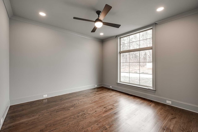 empty room featuring ceiling fan, dark hardwood / wood-style flooring, and crown molding