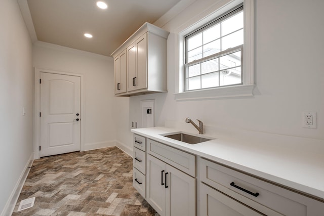 clothes washing area featuring hookup for a washing machine, sink, cabinets, and hookup for an electric dryer