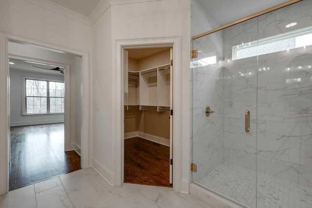 bathroom with a shower with shower door, wood-type flooring, and ornamental molding