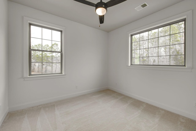 carpeted spare room with ceiling fan