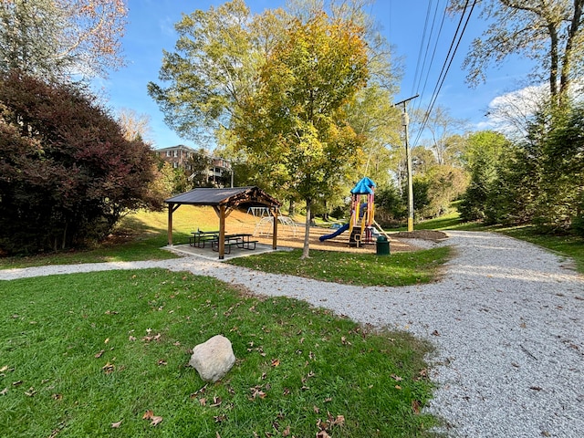 view of community featuring a playground, a yard, and a gazebo