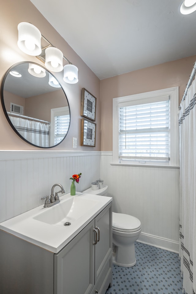 bathroom featuring vanity and toilet