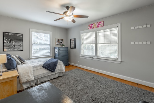 bedroom with ceiling fan and wood-type flooring