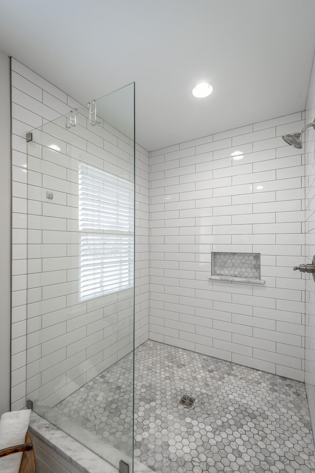 bathroom with a tile shower