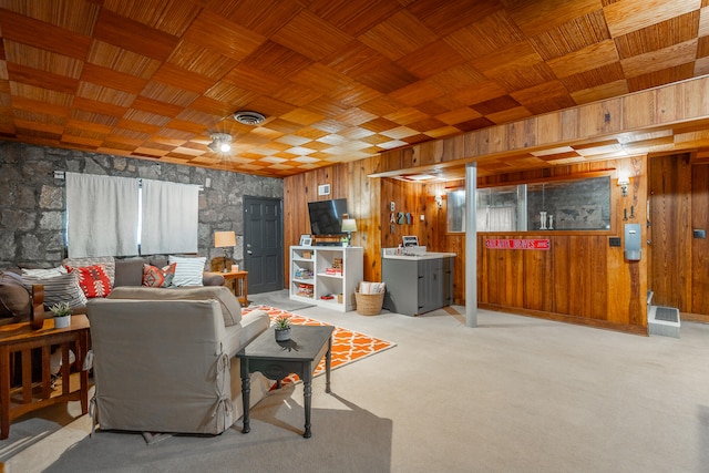 carpeted living room with washer / dryer, wooden ceiling, and wooden walls