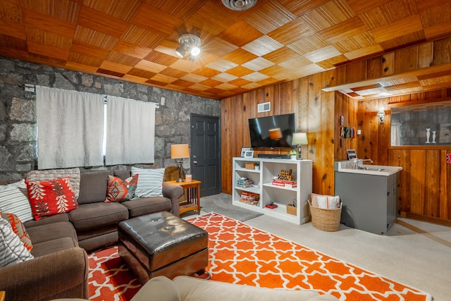 living room featuring light carpet, wooden ceiling, and wooden walls