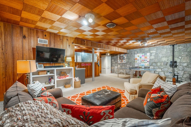 living room featuring wood walls and light carpet