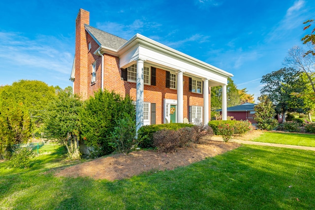 greek revival inspired property with a front yard