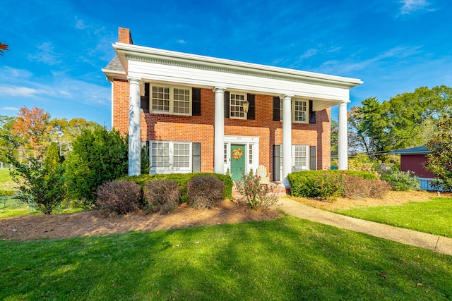 greek revival inspired property with a front lawn