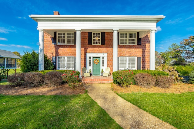 greek revival house with a front yard