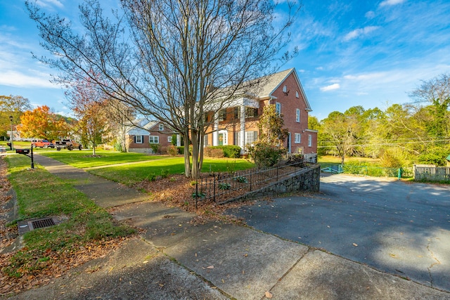 view of side of property with a yard