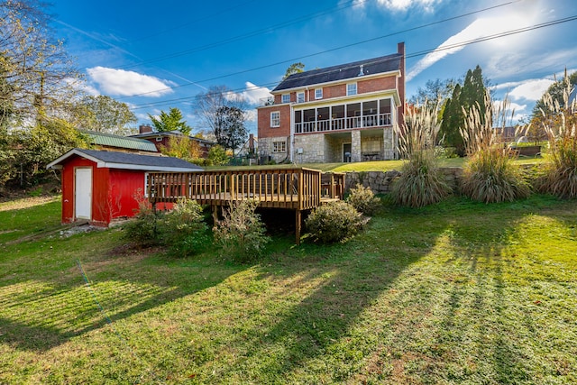 view of yard featuring a storage unit and a deck