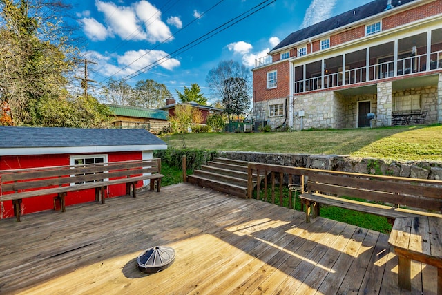 wooden deck featuring a lawn and a sunroom