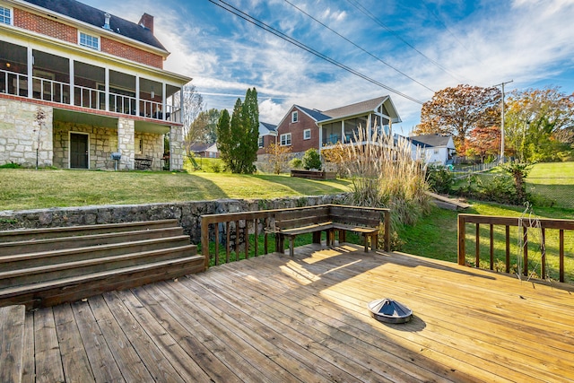 wooden deck with a sunroom and a yard