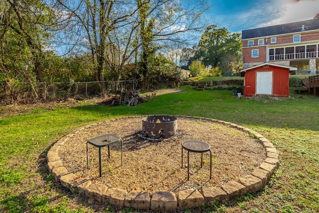 view of yard featuring a shed and an outdoor fire pit