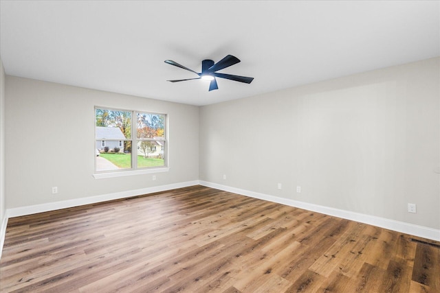 spare room with hardwood / wood-style floors and ceiling fan