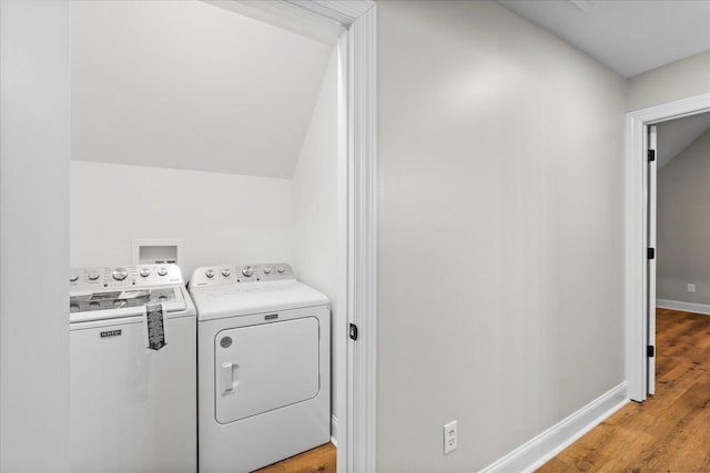 washroom featuring separate washer and dryer and light hardwood / wood-style flooring