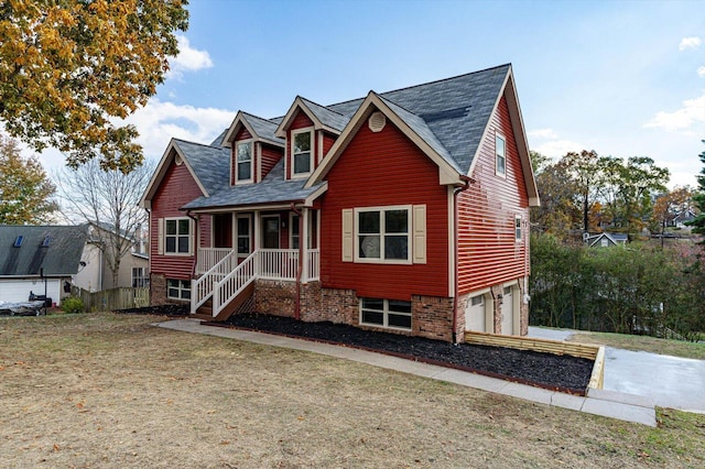 view of front of property with covered porch and a garage