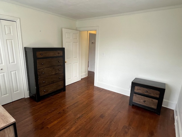 unfurnished bedroom featuring dark hardwood / wood-style floors, ornamental molding, and a closet