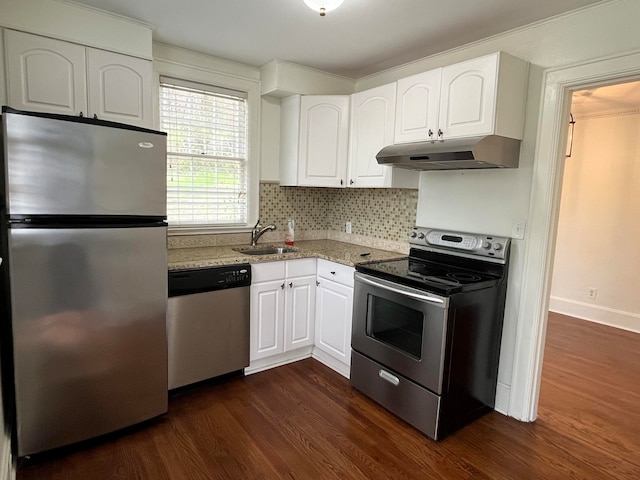 kitchen featuring white cabinets, appliances with stainless steel finishes, light stone counters, and dark wood-type flooring