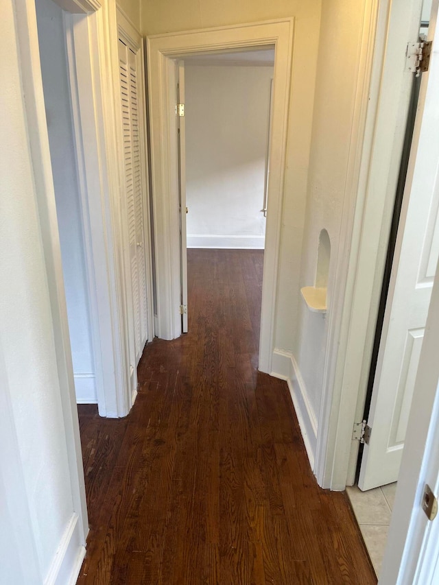 corridor with hardwood / wood-style floors