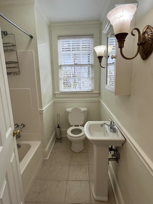 bathroom with tile patterned floors, toilet, ornamental molding, and shower / washtub combination