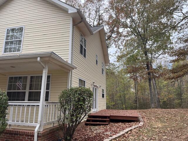 view of property exterior with a deck