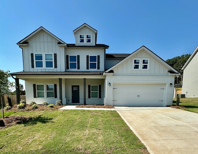 view of front of property with covered porch, a front yard, and a garage