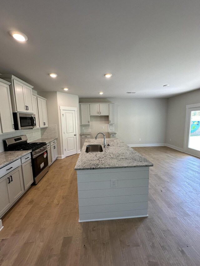 3349 Grassy Fields Ln Unit 177, Apison, TN 37302 - kitchen with stainless steel appliances, a sink, recessed lighting, a center island with sink, and light wood finished floors