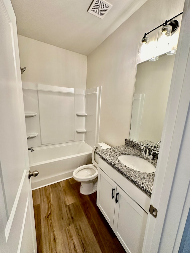 full bathroom with vanity, toilet, wood-type flooring, and bathtub / shower combination