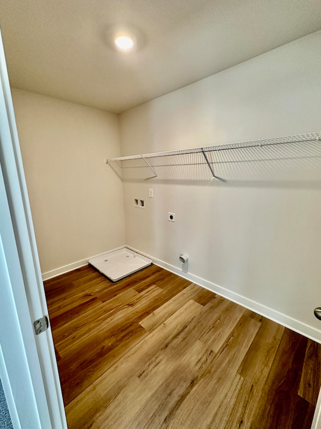 washroom with hookup for an electric dryer, hardwood / wood-style flooring, and washer hookup