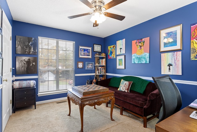 home office featuring ceiling fan and light carpet