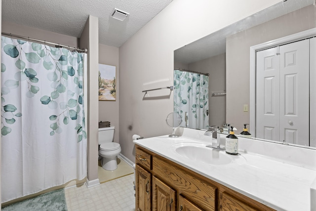 bathroom featuring vanity, a textured ceiling, and toilet