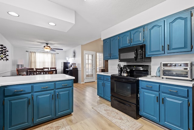 kitchen with black appliances, ceiling fan, light wood-type flooring, blue cabinetry, and a textured ceiling