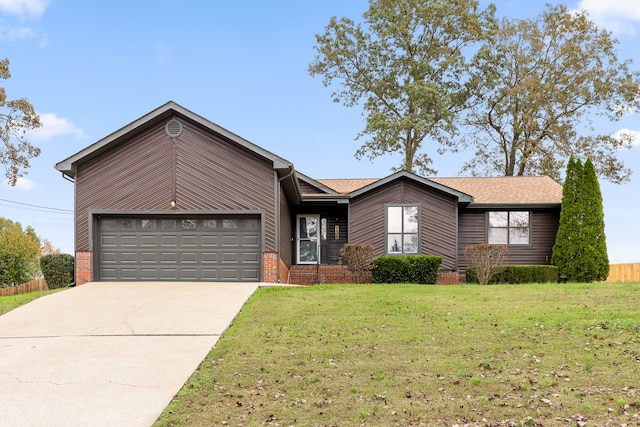 ranch-style home featuring a garage and a front lawn