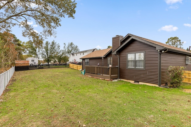 rear view of house featuring a yard and a deck