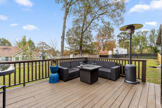 deck with a yard and an outdoor living space with a fire pit