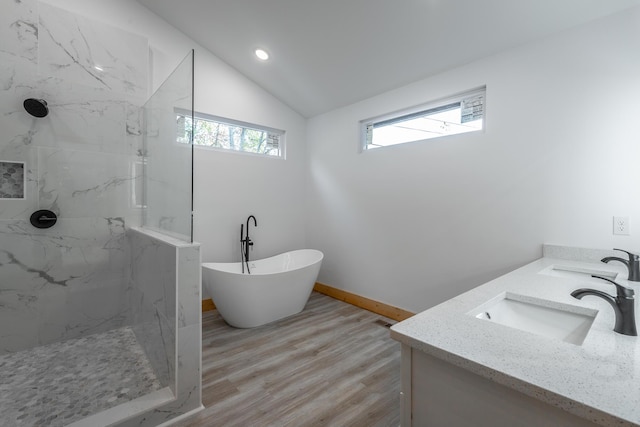 bathroom with hardwood / wood-style floors, vanity, separate shower and tub, and lofted ceiling