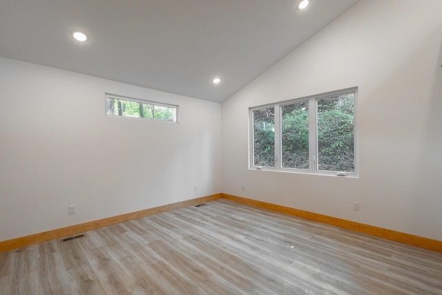 unfurnished room featuring light hardwood / wood-style flooring and vaulted ceiling