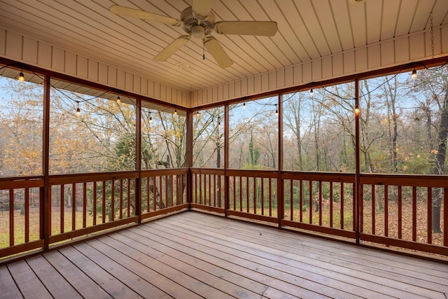 unfurnished sunroom with ceiling fan and wooden ceiling