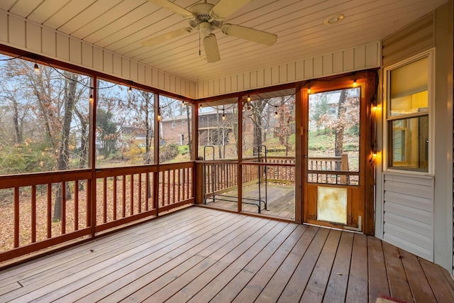 unfurnished sunroom with ceiling fan and wood ceiling