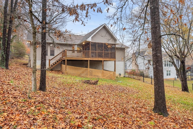 back of house featuring a deck and a sunroom