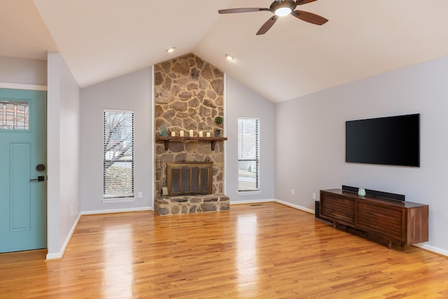 living room with a wealth of natural light, ceiling fan, and light wood-type flooring